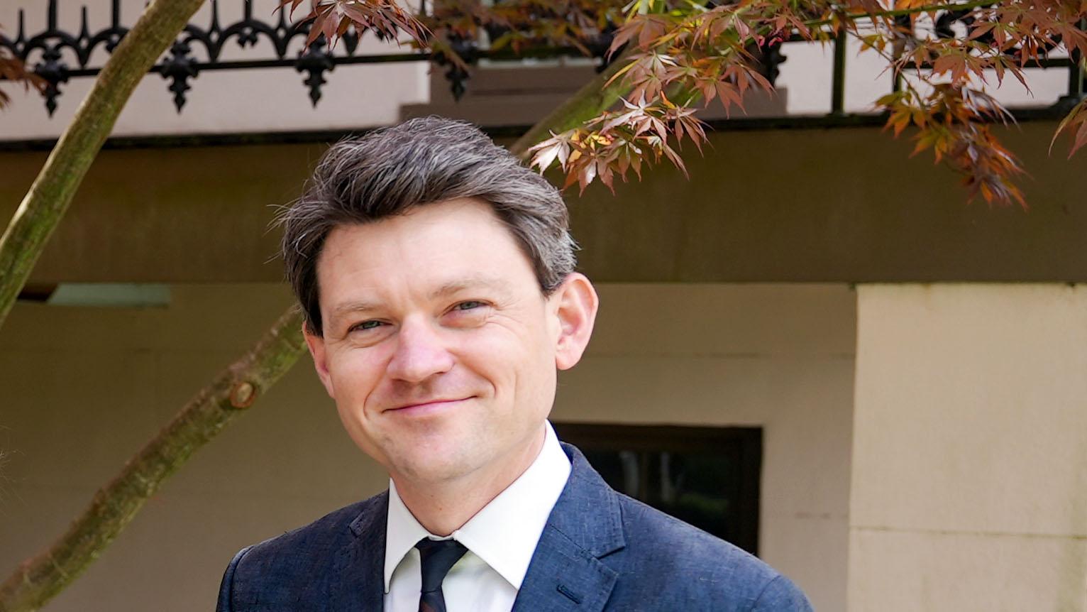 Designer Clark Stancil shown from shoulders and up in front of a tree