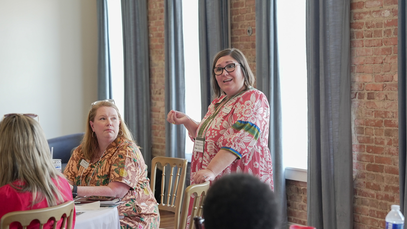 Natalie Bradley stands, speaking to a crowd at the PROPEL Ramble