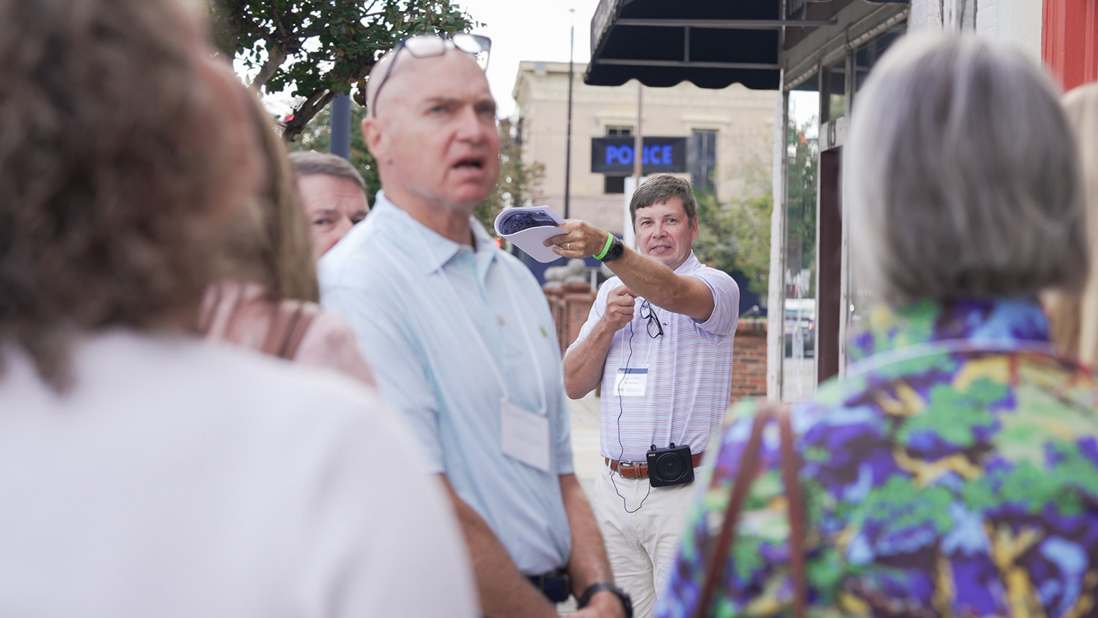 Jason Dunn speaks to a group on a walking tour